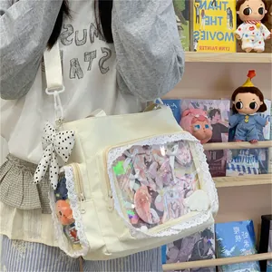 Detailed view of a cream tote bag with lace trim and clear display window on model.