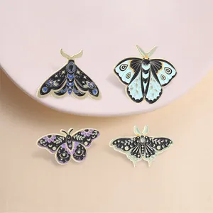 Detailed view of four celestial moth and butterfly enamel pins with intricate gold details