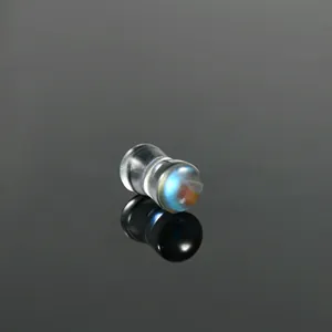 Detailed close-up view of an iridescent AB glass hourglass ear plug on reflective black