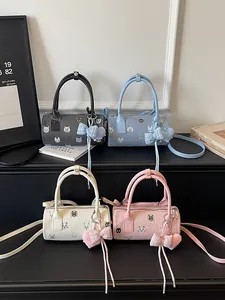 Fashionable cartoon cat print barrel handbags for women in four assorted colors.