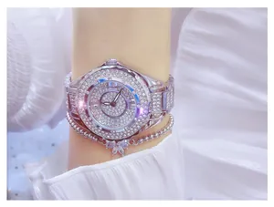 Close-up view of an elegant full rhinestone ladies watch with a butterfly bracelet on wrist