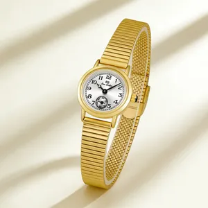 Detailed view of a vintage gold ladies watch with a unique bamboo stretch strap and dial