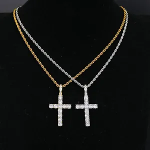 Detail view of iced out cross pendant necklaces in gold and silver hip hop style