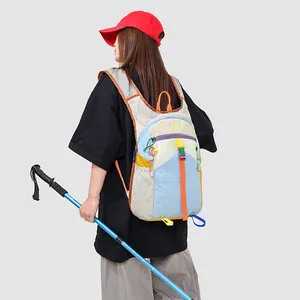 Detail view of a colorful patchwork outdoor backpack worn by a hiker with a pole.