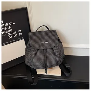 Detail view of the black checkered mini backpack with 'YOU JI BEAR' branding