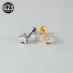 Close-up of G23 titanium star-shaped labret studs with clear zirconia stones.