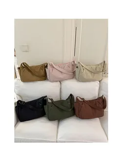 Large capacity lightweight crossbody tote bags in multiple colors displayed on a sofa