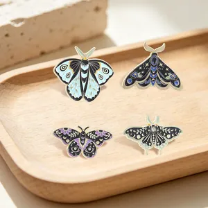 Vintage celestial moth and butterfly enamel pins with floral details on wood