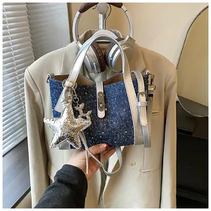 Exquisite blue denim bucket bag featuring silver handles and a star charm detail