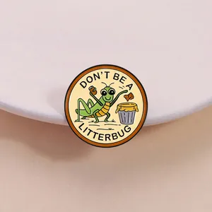Détail macro de l'épingle en émail avec la sauterelle 'Don't Be a Litterbug' dessin