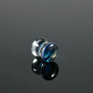 Detailed side view of a blue swirled glass ear plug expander with a waist drum shape.