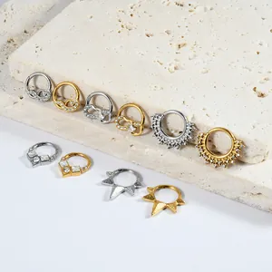 Detailed view of assorted gold and silver stainless steel piercing rings with zircon