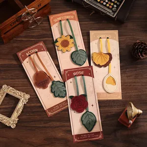 Detailed view of vintage leather floral bookmarks with sunflower and rose designs.