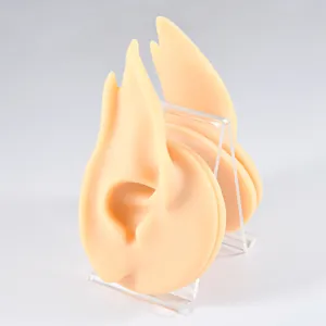 Detailed view of silicone elf ear models for jewelry display on clear acrylic stands