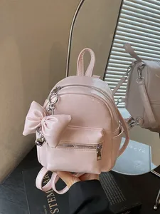 Modischer rosa Mini-Rucksack für Damen mit einer großen dekorativen Schleife vorne