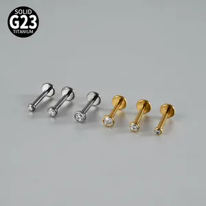 Detailed macro view of G23 titanium labret studs with bezel-set clear cubic zircons