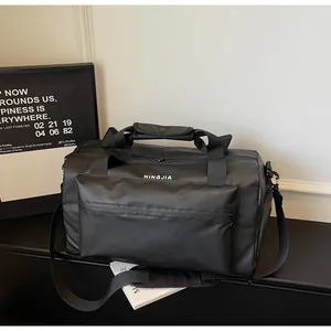 Black large-capacity travel duffel bag for fitness and hiking on a minimalist shelf.