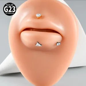 Macro view of G23 titanium heart and triangle zircon lip studs on silicone lip model
