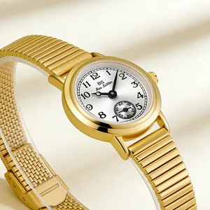 Close-up of BS Bee Sister vintage gold watch with bamboo style band and sub-dial.