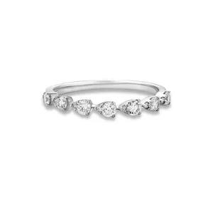 Macro view of dainty S925 sterling silver ring with pear and round cut cubic zirconia