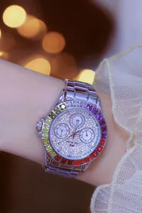 Close-up of ladies' watch with rainbow gradient rhinestone bezel and silver link strap