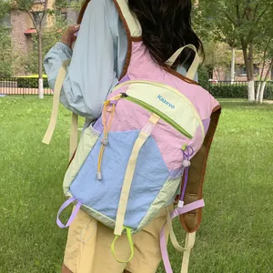 Detailed back view of a multicolor dopamine hiking backpack on an outdoor model