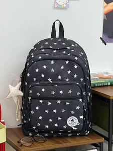Stylish black backpack with white star pattern and decorative star charm