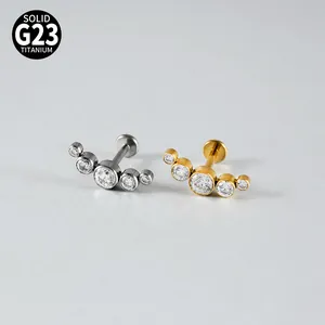 Close-up of crescent G23 titanium lip studs with graduated cubic zirconia stones