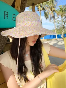 Detailed look at the floral bucket hat with white lace trim for summer sun protection