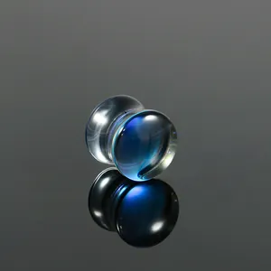 Close-up detail of a blue AB iridescent glass ear plug with a double flared design