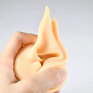 Close-up view of a soft and flexible flesh-toned silicone ear model for jewelry display
