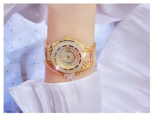 Luxury gold-toned women's watch encrusted with sparkling rhinestones detail view