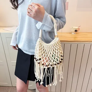 Detail of hand-woven bucket bag with wooden beads and tassel fringe for summer