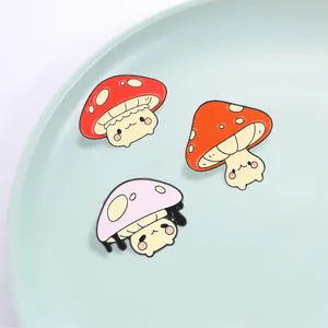 Cute set of three anthropomorphic mushroom enamel pins in red, orange, and pink