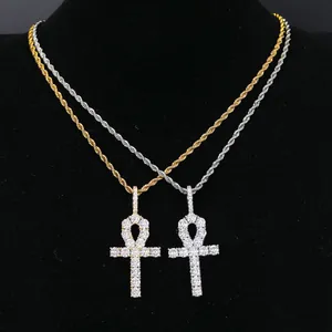 Detailed macro shot of hip-hop iced out Ankh cross pendant necklaces in gold and silver.