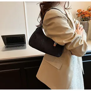 Chic black jacquard underarm bag with bead charm styled with a beige blazer for commute