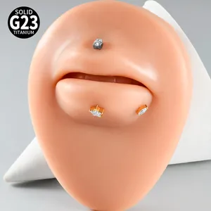 Close-up macro view of G23 titanium lip piercing studs with zircon insets on silicone model