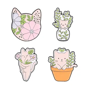 Set of cute cartoon cat and plant enamel pins with pastel floral designs on white background.