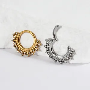 Close-up of gold and silver stainless steel tapered segment rings with white zircon stones (92 chars)