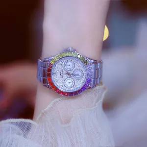 Close-up detail of women's silver watch featuring a vibrant rainbow gradient gemstone bezel.