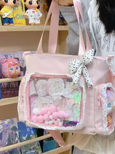 Large pink ita bag with transparent window and lace trim for character display