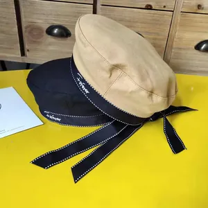 Stylish beret hats in black and khaki featuring embroidered 'forever' ribbon and bow