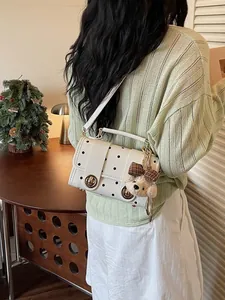 Retro white polka dot crossbody bag for women featuring a cute plush bear charm