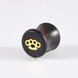 Ebony wood ear expansion gauge plug with golden brass knuckles inlay detail view