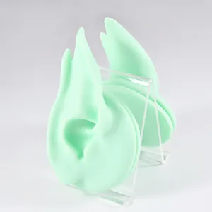 Detailed mint green silicone elf ear model on clear acrylic stand for earring display