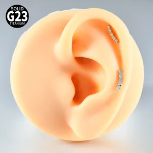 Detailed macro view of G23 solid titanium crescent piercing jewelry with clear zircons.