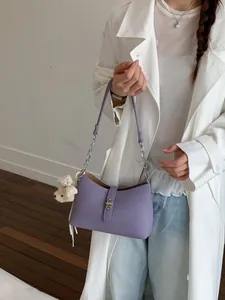 Stylish lavender purple underarm shoulder bag with silver chain and cute teddy bear charm.
