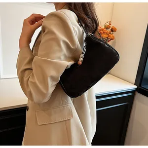 Side view detail of a black textured underarm bag in a modern Chinese fashion style