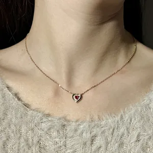 Elegant S925 sterling silver heart pendant necklace with red gemstone worn on model