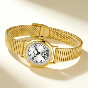 Close-up view of a vintage gold women's watch featuring a white dial and bamboo strap